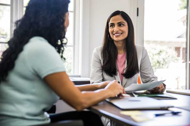 Business person talking to client in office